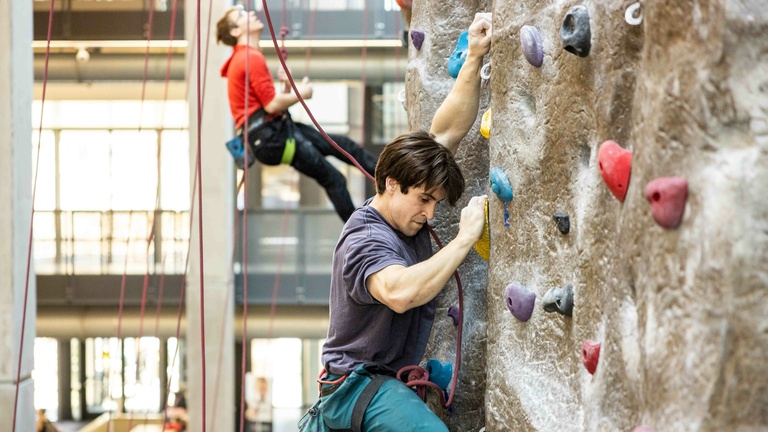 A participant climbing his way up the wall.