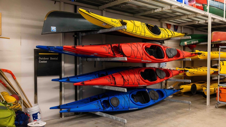 Photos of red, blue, yellow kayaks mounted horizontally for storage.