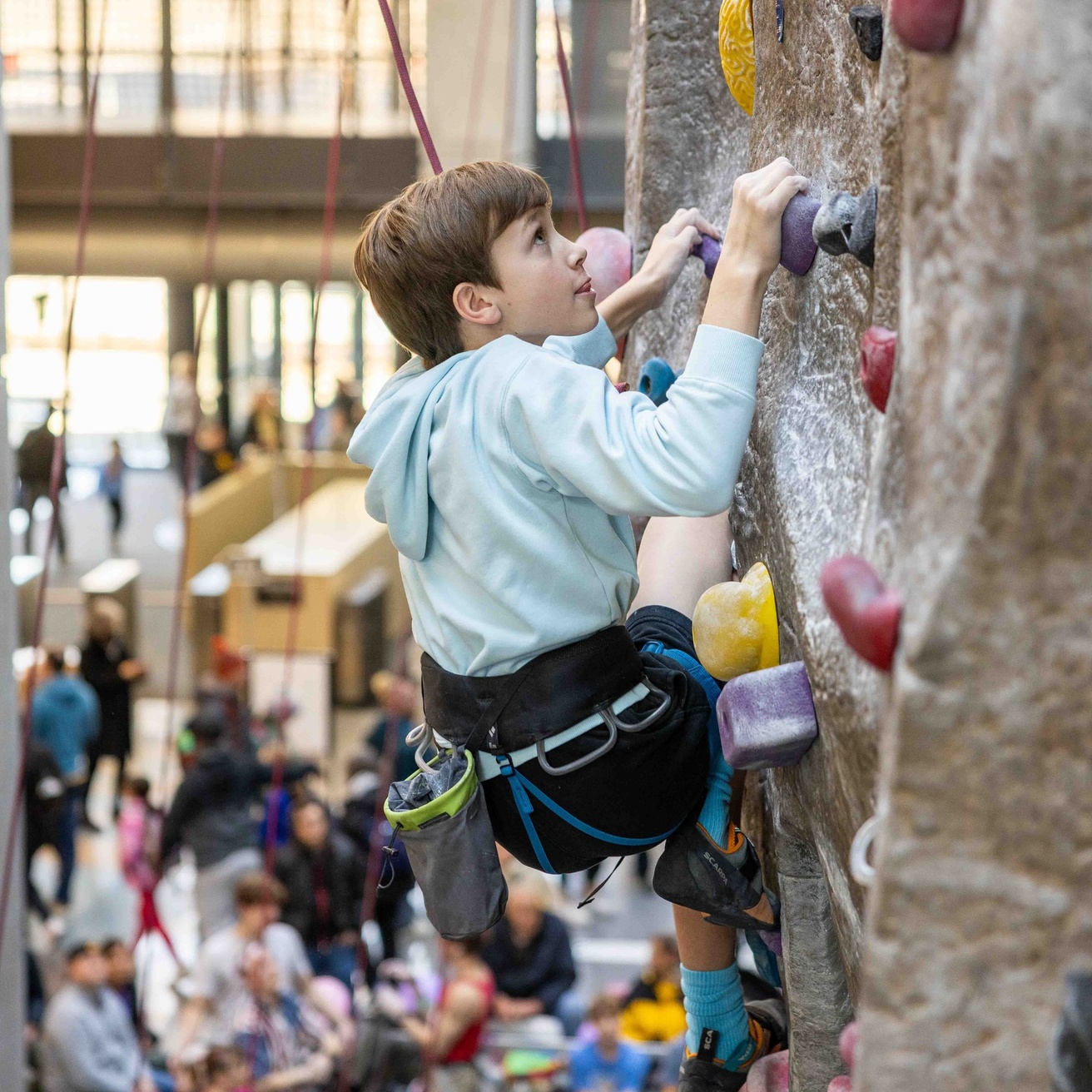 A photo of a junior participant on the top rope wall at the CRWC.