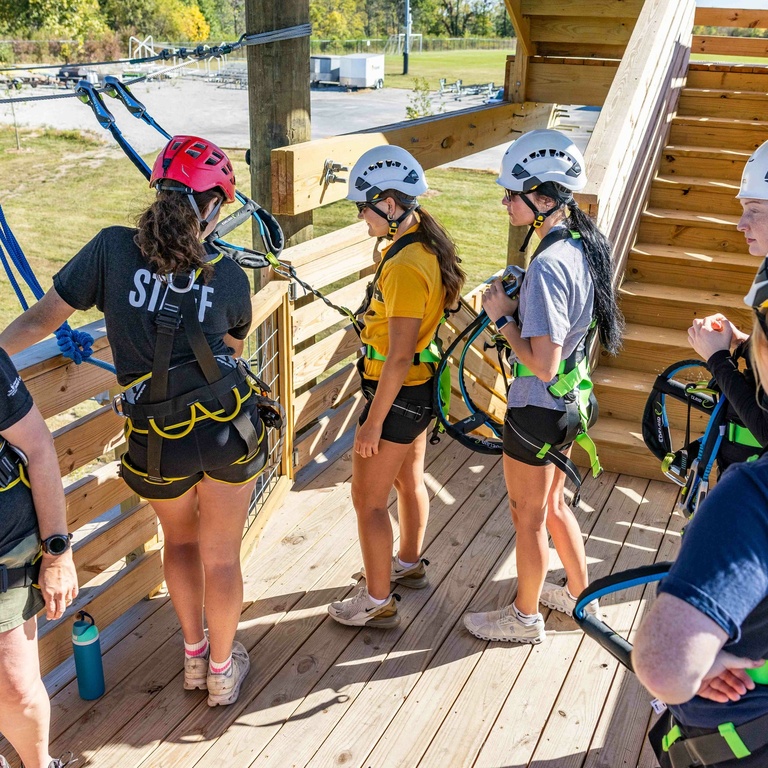 Participants being helped by UI Challenge Course staff. 