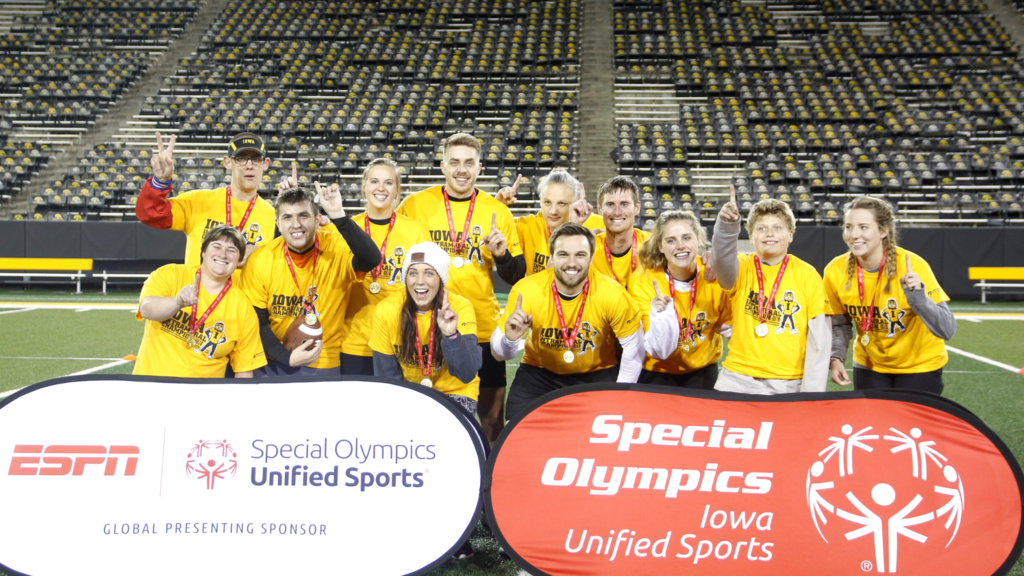 Special Olympics Iowa Unified Sports in front of champion unified athletics flag football team.