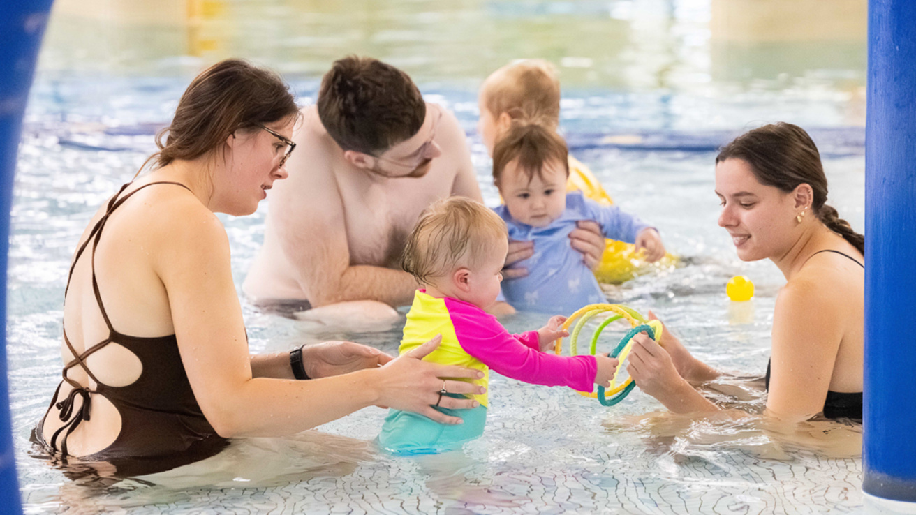 A group of swim instructors, parents, and children in the Recreation Pool.
